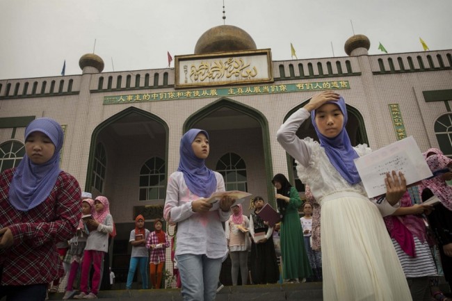  Hui Muslim girls leave a graduation for an Islamic studies course during the holy month of Ramadan at a mosque on July 22, 2014 in Sangpo, Henan Province, China. Kevin Frayer / Getty Images