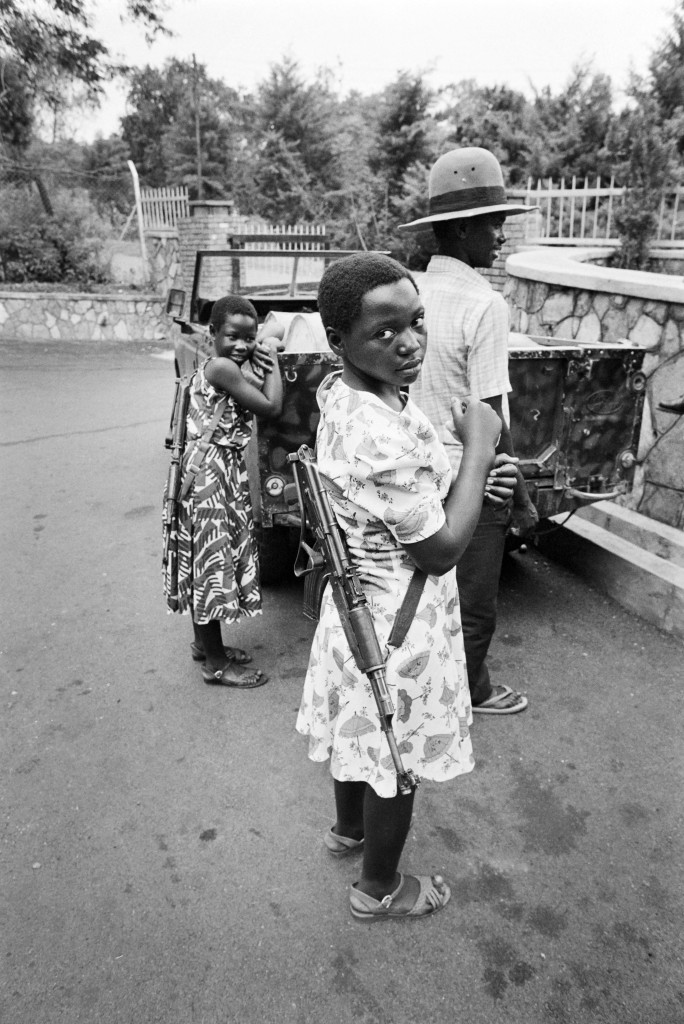 National Resistance Army girl soldier poses with their kalashnikov, 26 January 1986 in Kampala. The children soldiers of the NRA are mostly orphans whose parents were killed during the Obote regimes killing excesses. They are reputedly to be among the best and bravest fighters of Museveni's guerilla force. The NRA rebellion, lead by Yoweri Museveni took power 26 January 1986, after five years of fighting against the second Obote regime, popularly known as "Obote II", and its armed forces, the Uganda National Liberation Army (UNLA). (Photo credit should read ALEXANDER JOE/AFP/Getty Images)