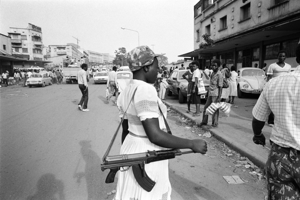 National Resistance Army young girl soldier poses with her kalashnikov, on January 1986 in Kampala. The children soldiers of the NRA are mostly orphans whose parents were killed during the Obote regimes killing excesses. They are reputedly to be among the best and bravest fighters of Museveni's guerilla force. The NRA rebellion, lead by Yoweri Museveni took power 26 January 1986, after five years of fighting against the second Obote regime, popularly known as "Obote II", and its armed forces, the Uganda National Liberation Army (UNLA). (Photo credit should read ALEXANDER JOE/AFP/Getty Images)