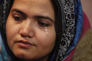 In this photo taken on Jan. 26, 2016, Kainaat Soomro weeps during an interview with The Associated Press in Karachi, Pakistan. She was 13 years old and on her way to buy a toy for her newborn niece when three men kidnapped her, held her for several days and repeatedly raped her. Eight years later, she is still battling for justice. (AP Photo/Shakil Adil)