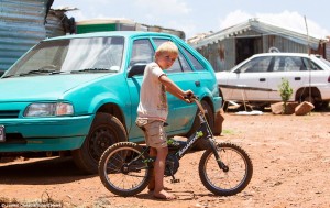 Old cars sit next to the flimsy shelters and makeshift toilets in the camp where families are forced to survive on less than £30 a month 