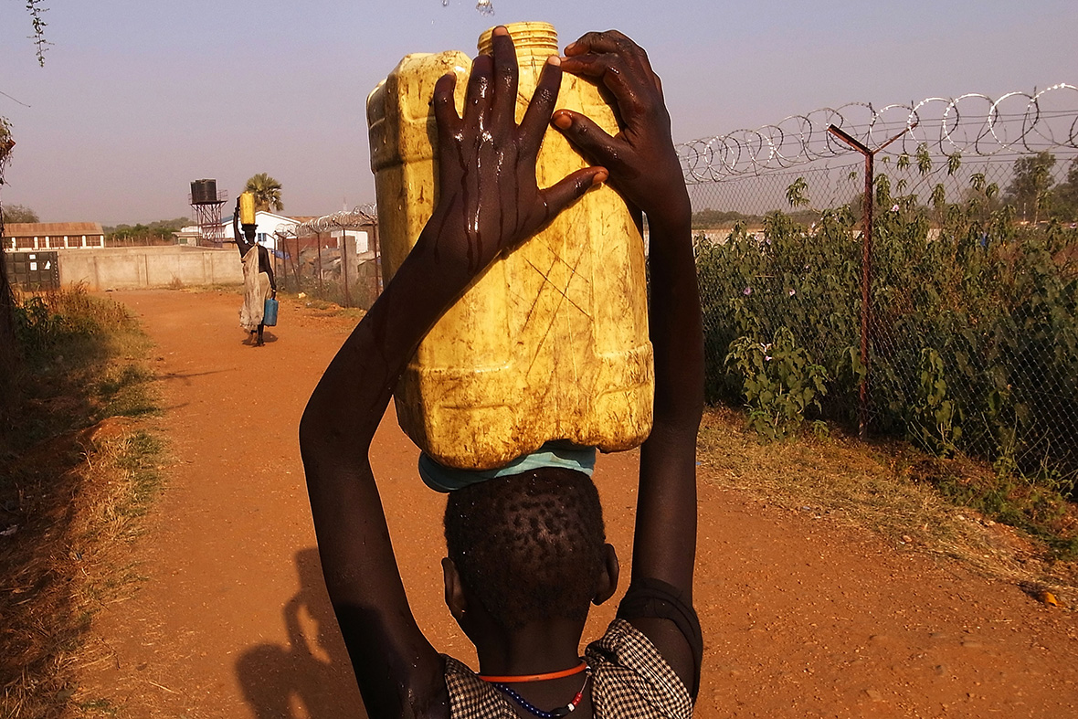 11 January, 2011: A girl carries water back to her home in an area for displaced Sudanese in the southern Sudanese city of Juba, SudanSpencer Platt/Getty Images