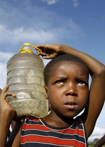 7 December 2008: A boy carries water for domestic use he fetched from an untreated well which has been a major source of cholera in Harare, ZimbabweDesmond Kwande/ AFP