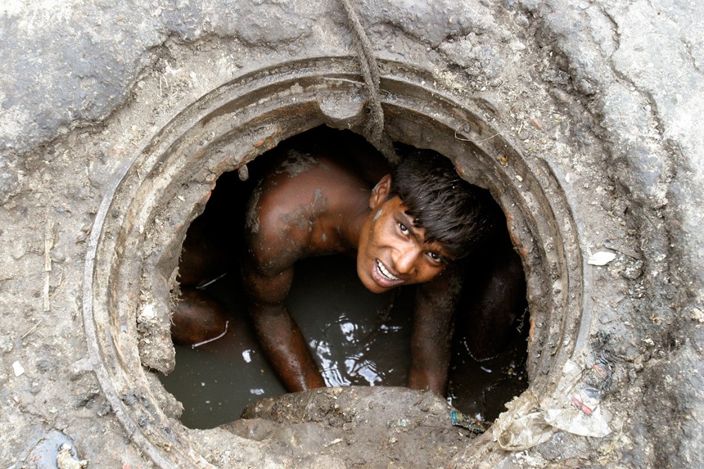 25 April 2007: A labourer cleans an underground sewage in DhakaRafiqur Rahman/ Reuters