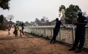 U.N. peacekeepers from Burundi speak to women and girls walking near their base Feb. 15 in the Castors neighborhood in Bangui. Some of the troops sent in to safeguard the population have been accused of committing abuses. Photos by Jane Hahn