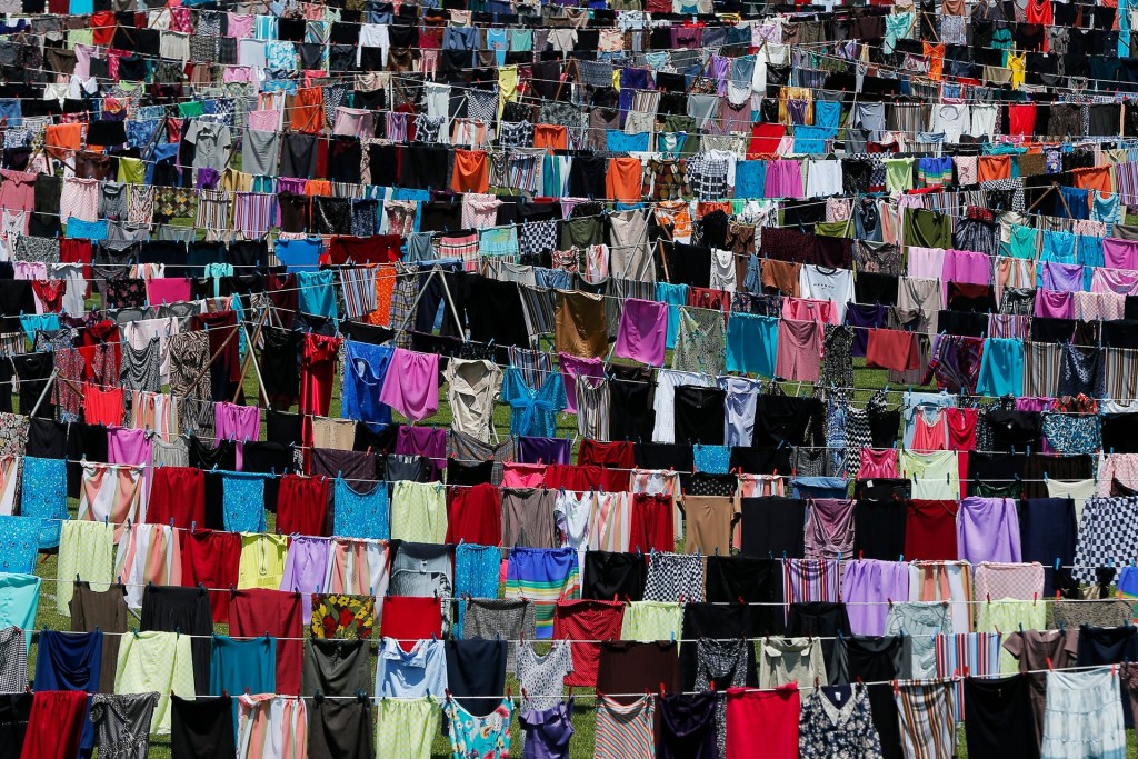 Clothes hang on lines across a football stadium in Pristina, Kosovo, in a work dedicated to the survivors of sexual violence during the 1998-99 war.