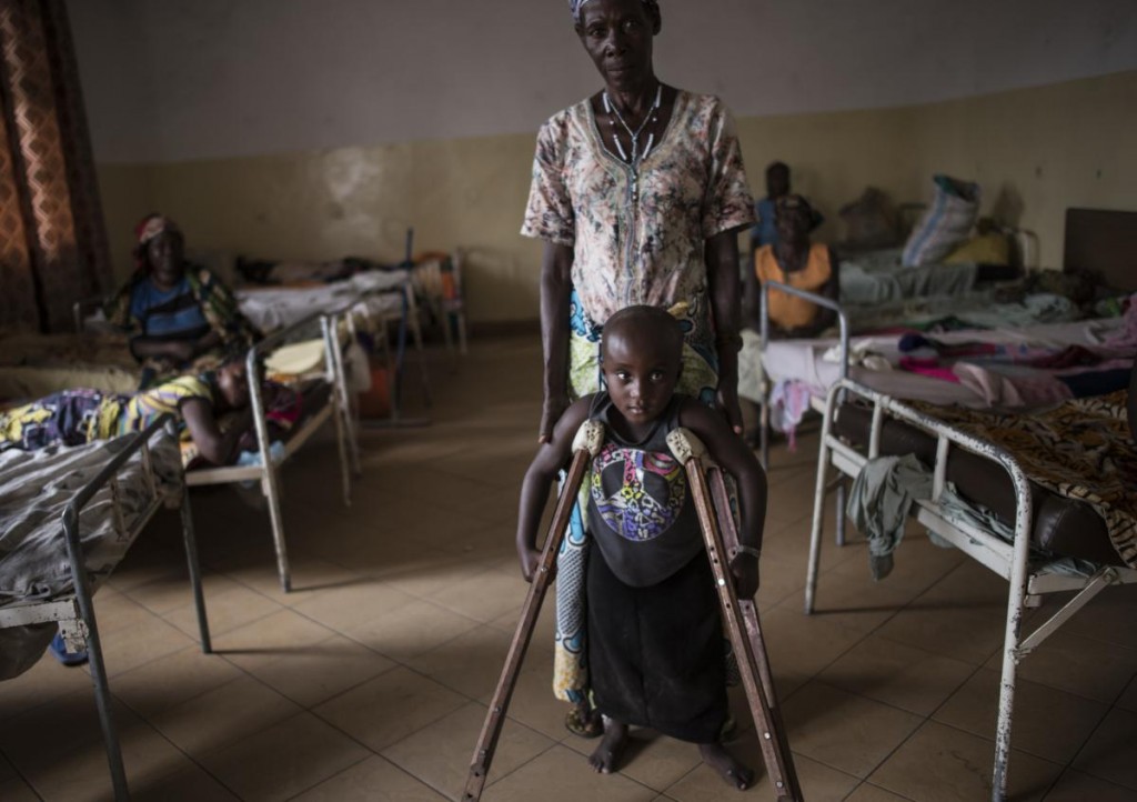 Kanyere Neema, 7, is held up by her grandmother, Ndahondi Domina, 53, as she poses for a portrait in the Heal Africa hospital in Goma, in the Democratic Republic of Congo, December 5, 2015. Two years prior, Kanyere's village of Ishasha was attacked by armed men, and her parents were killed in front of her; she was raped so many times by various men that she was left paralyzed, and stopped speaking. As the world takes more notice of rape being used as a weapon of war, congos dark history of sexual violence in conflict has much to teach the world on how to prevent rape, and how it can help survivors heal physically, emotionally, and socially. (Credit: Lynsey Addario for Time Magazine) Kanyere's story: Ishasha, near Uganda border. Kanyere came here when she was 5. In ishasha fdlr right before harvest and cause panic and trouble and rape people and terrorisE so people run away and they can steal the harvest. When they came l, they killed the father and mother, and the grandmother luckily was out of the village at the market. They killed so many people, it wasn't only kanyere's parents who were killed, they raped her. It was difficult to estimate how many men raped her because she was left paralysed. After she was brought here, we treated her, she had big wounds, she had fistula and a lot of things. After she finished the treatment she was sent back home. Then the grandmother brought her back for supports and the project to give support is over. I can't say she is healed. She doesn't control her urine and when she has to go caca. To me it's not about psychological issue, it's about physical issue, and she was raped by adults when she was still very young. Why would people rape a 5 year old girl: first it is because those predators have no mercy. The other thing is to make people hurt themselves Forcing people to hate themselves, hate their country, to hate everything. Once you have been raped, you don't have feelings of being human. You just want Grandmother: