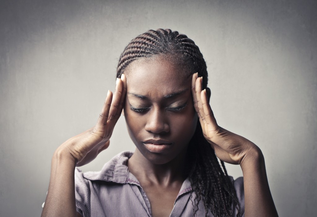 Young African woman suffering from headache