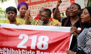 #BringBackOurGirls campaigners with an updated poster after the news that a teenager kidnapped from Chibok more than two years ago has been rescued. Photograph: Afolabi Sotunde/Reuters 