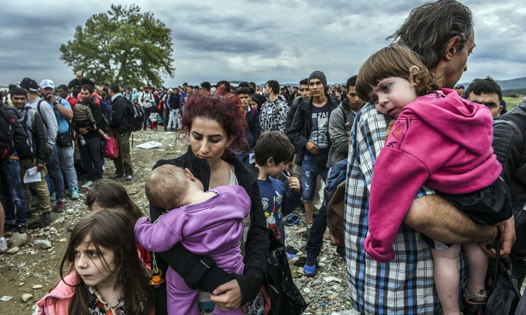 People queue to be registered after crossing the border from Greece to Gevgelija in Macedonia, September 2015. Photograph: Armend Nimani/AFP/Getty Images