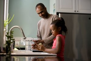 African American father was shown in the process of teaching his