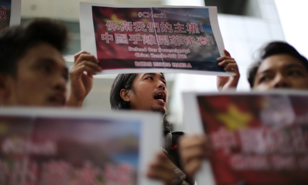 Filipino activists hold slogans in front of the Chinese consulate to protest China’s territorial claim over the disputed Spratlys island group in the South China Sea. Photograph: Aaron Favila/AP