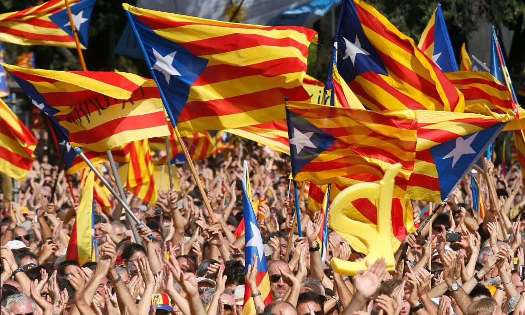 People wave Catalonia flags at a rally in Barcelona. A recent poll showed that 47.7% of Catalans support independence. Photograph: Albert Gea/Reuters