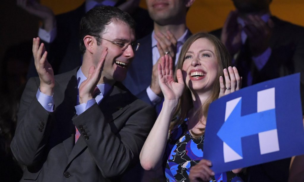 Chelsea Clinton and husband Marc Mezvinsky smile as Hillary Clinton appears on screen live during the second day of the convention. Photograph: Mark J Terrill/AP