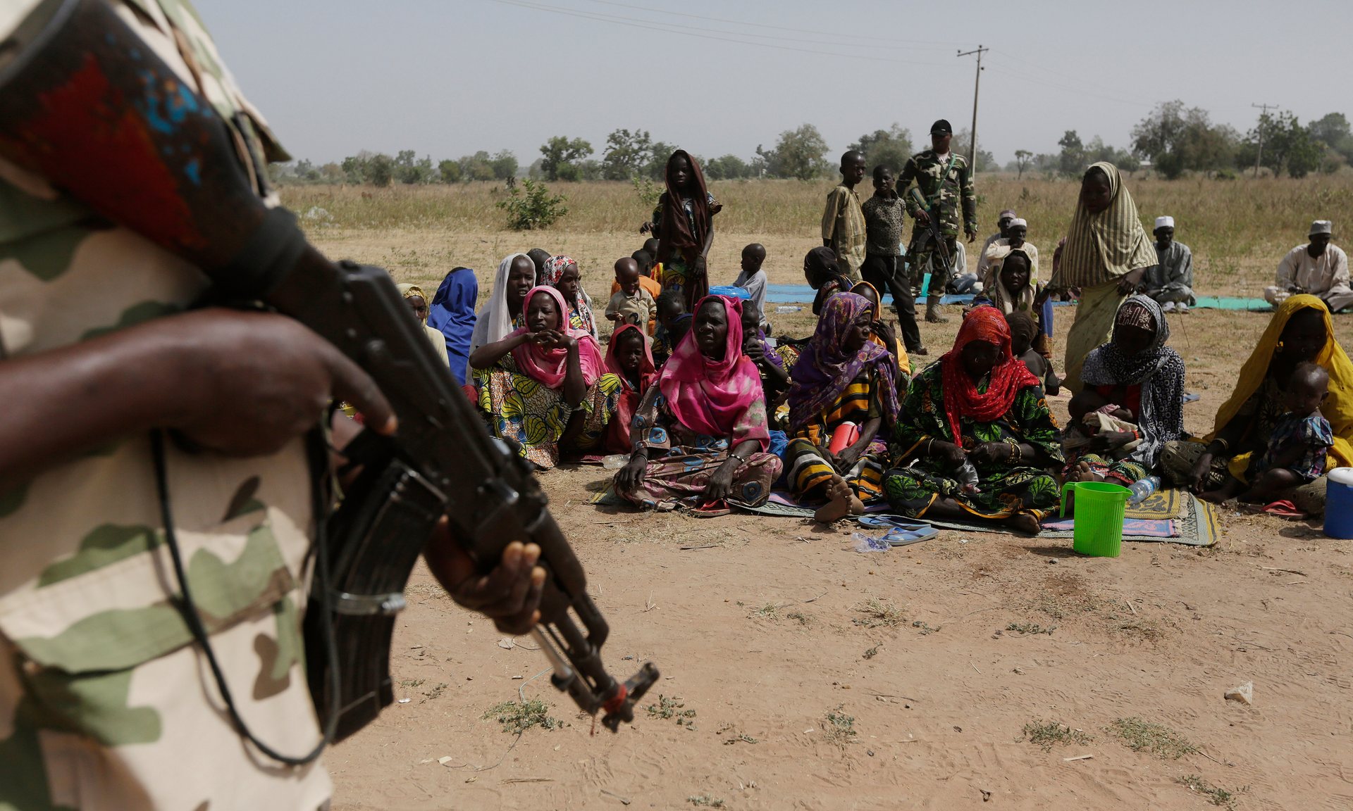 Soldiers guard Nigerians fleeing Boko Haram. In recent years northern Nigeria, Chad and Niger have suffered droughts that have fuelled political violence. Photograph: Sunday Alamba/AP