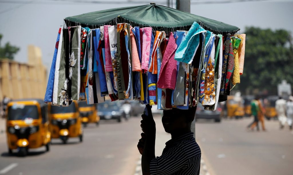 A man sells handkerchiefs on a street in Nigeria’s northern city of Kano, July 2016. DfID’s understanding of Nigeria’s informal employment sector is criticised in a new report. Photograph: Akintunde Akinleye/Reuters