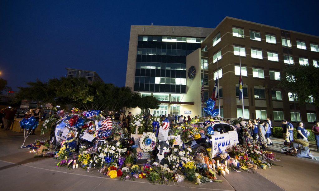 Tributes amass outside Dallas police headquarters on Friday following the shooting of 12 officers and two civilians. Photograph: Anadolu Agency/Getty Images