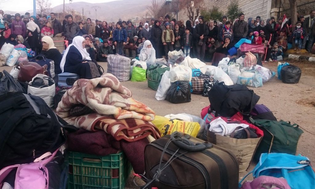 Syrians waiting for the arrival of an aid convoy in Madaya in January. Photograph: Marwan Ibrahim/AFP/Getty Images