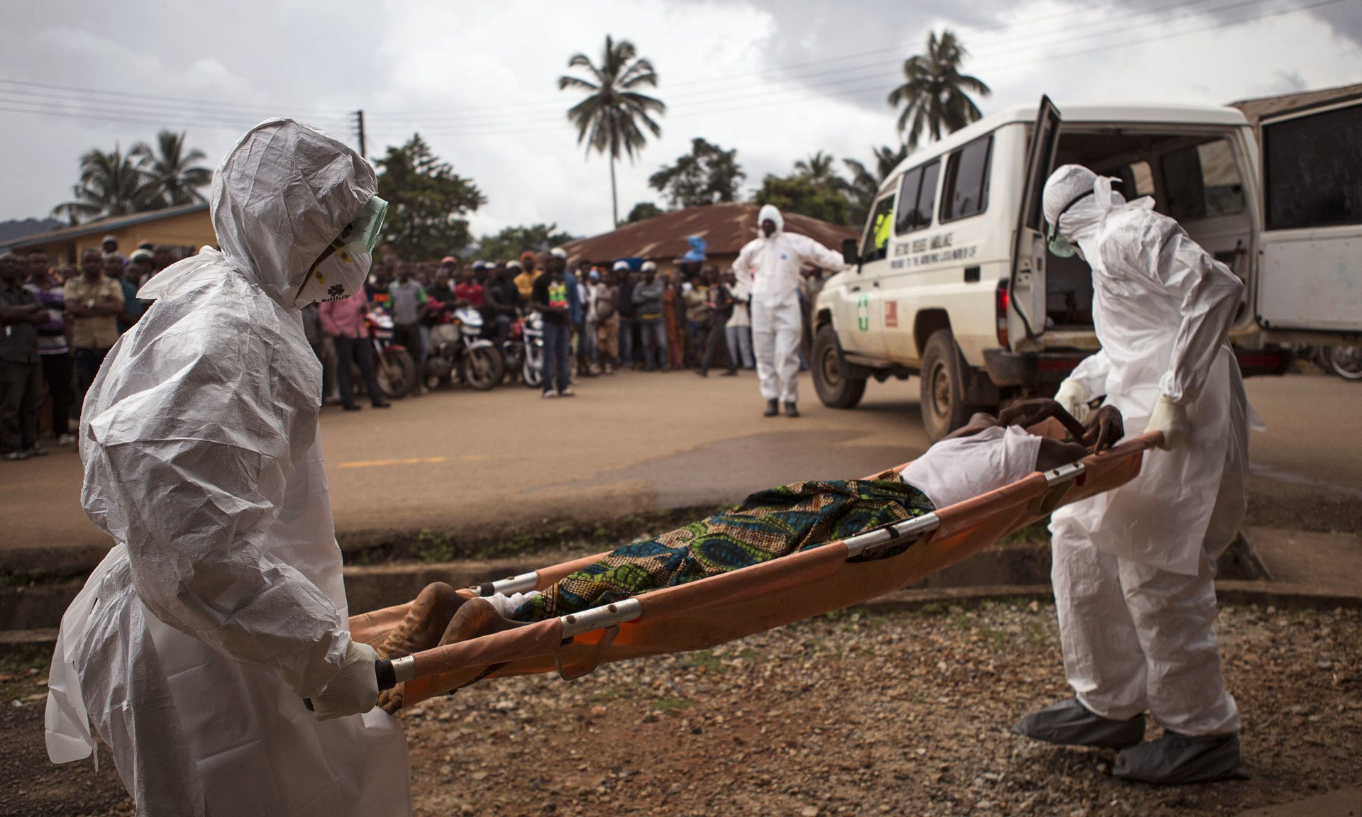 Healthcare workers carry a suspected Ebola sufferer to an ambulance in Kenema. Photograph: Tanya Bindra/AP