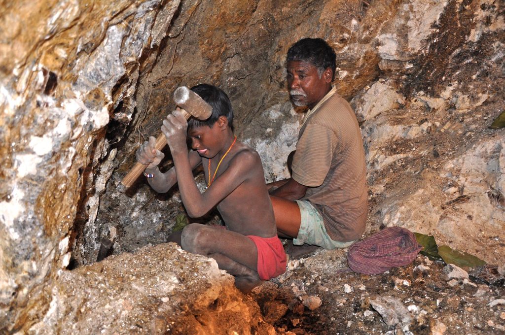 In this photograph from 2013, seven-year-old Karulal works with his father in a mica mine. Photograph: Peter Bengtsen