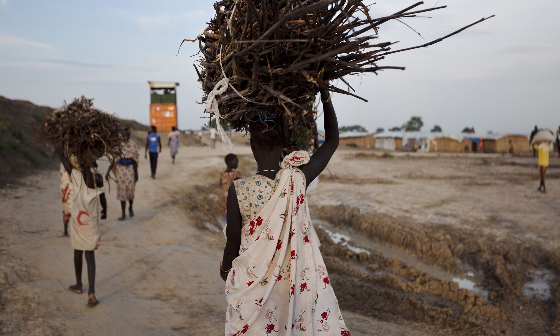 A young woman en route to the UN base outside Bentiu in Unity state, South Sudan, after collecting firewood. Such expeditions leave women and girls vulnerable to attack. Photograph: Tristan Mcconnell/AFP/Getty Images