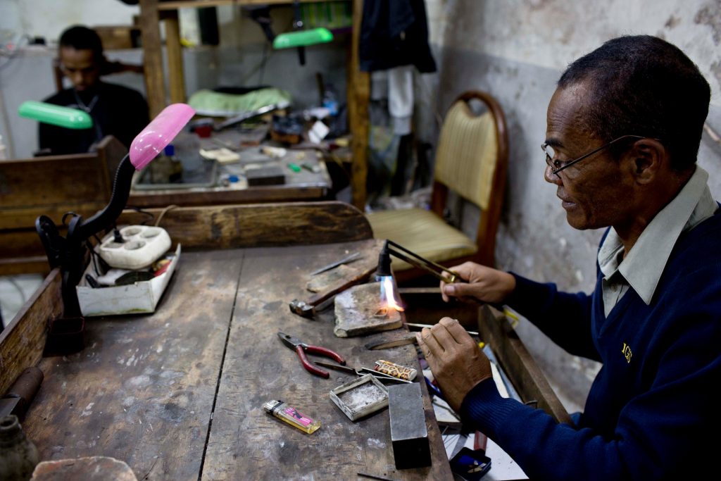 A jeweller crafts local gold into a ring at a jewellery workshop in Antananarivo, April 2016. Photograph: Kate Holt