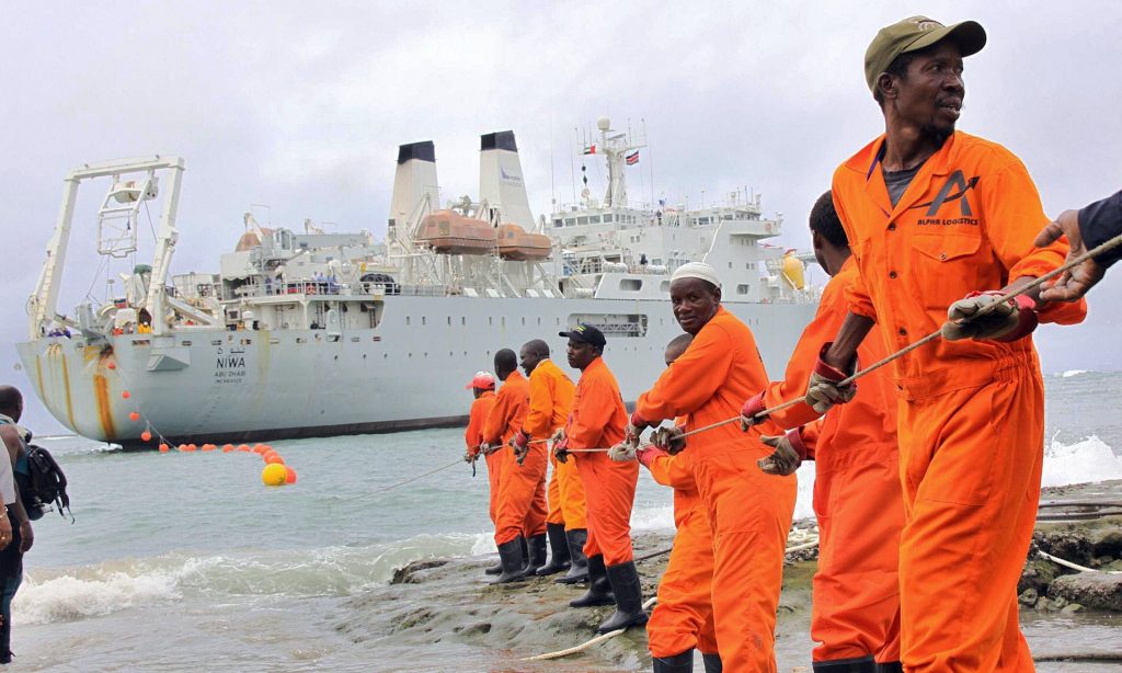 Bringing broadband to east Africa: workers haul part of a fibre optic cable to the shore at the Kenyan port town of Mombasa on 12 June 2009. Photograph: AFP/Getty Images