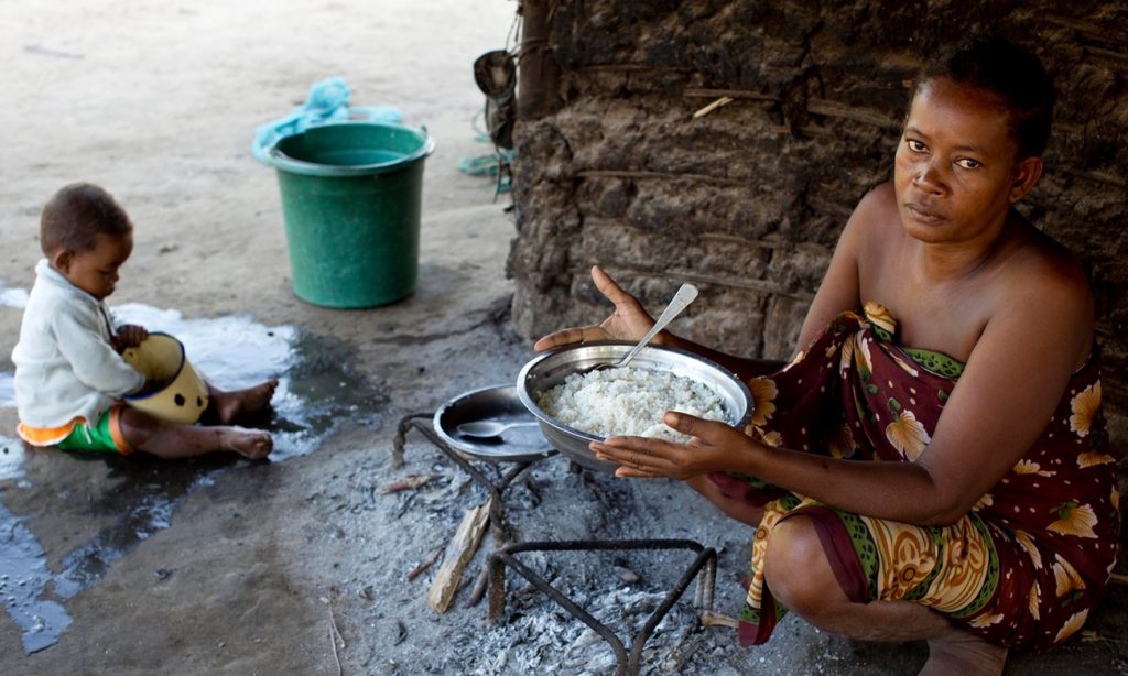 Monja, a mother of six children, prepares a meal of rice at her home in Bekalalao village in Madagascar. Photograph: Kate Holt/WaterAid 