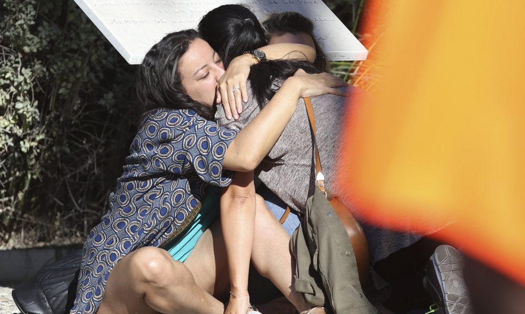 Survivors embrace each other near the scene of the attack in Nice. Photograph: Luca Bruno/AP
