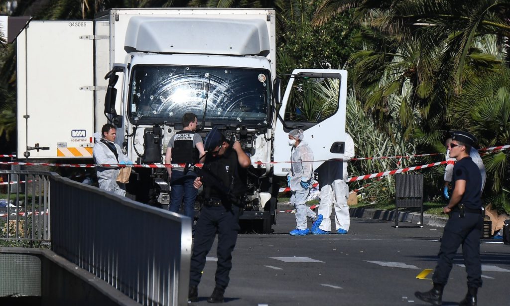 Forensics and police officers at the truck that rammed into a crowd and left 84 dead in Nice. Photograph: Anne-Christine Poujoulat/AFP/Getty Images