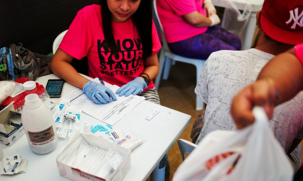 Health officials conduct rapid HIV testing during a fun run in Cebu City, December 2015. Photograph: Veejay Villafranca/Pulitzer Center on Crisis Reporting