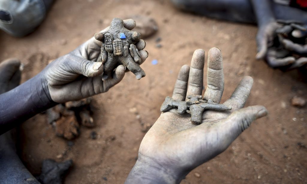 A child holds clay toys of a peacekeeper and a rifle in the UN camp for displaced people in South Sudan’s capital, Juba. Photograph: Jason Patinkin/AP