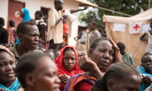 People wait to be registered as displaced persons in a South Sudan Red Cross compound in Wau. Photograph: Charles Lomodong/AFP/Getty Images