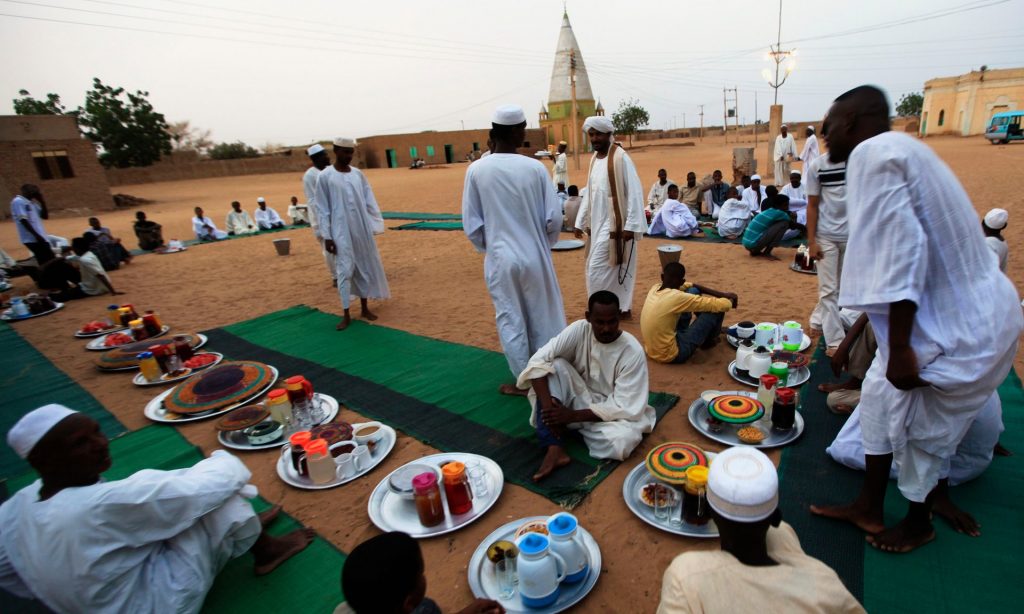Sudanese men in a suburb of Khartoum prepare to break their fast during Ramadan. Photograph: Mohamed Nureldin Abdallah/Reuters