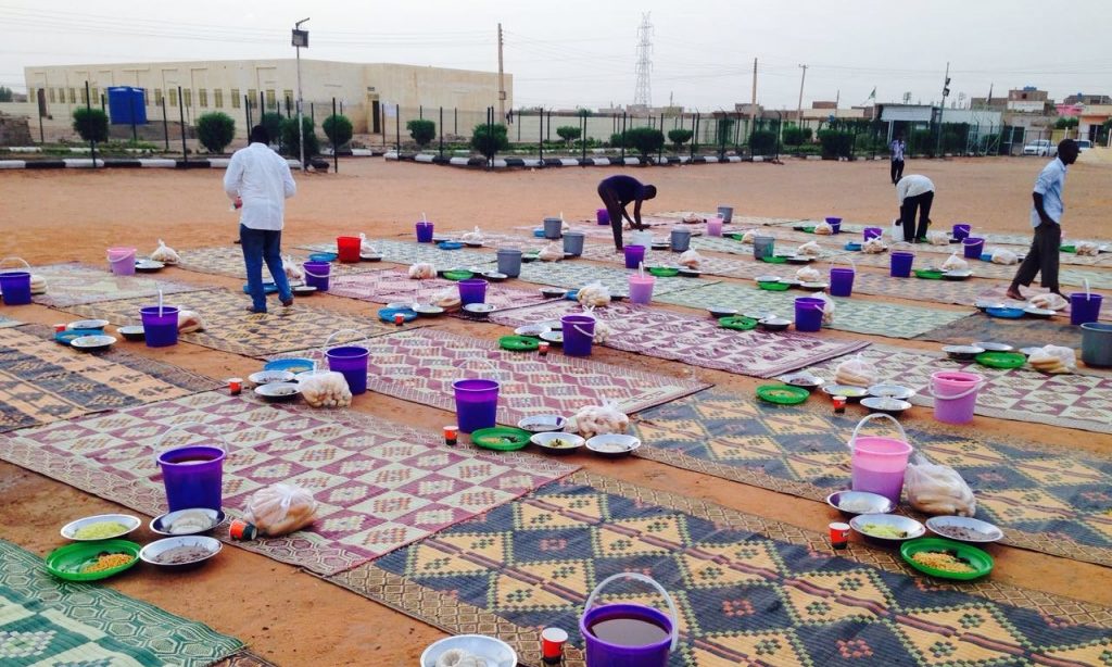 Volunteers prepare food aid for families in Khartoum’s suburbs. Photograph: Sadagaat