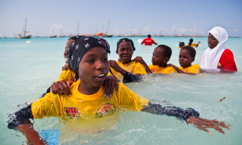 Lifeguards take to the water to train young people to swim in Zanzibar. Photograph: Mike Lavis/RNLI
