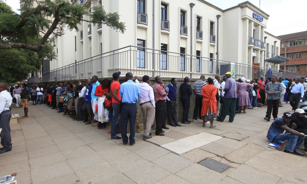 Zimbabweans wait to withdraw cash in Harare, May 2016. Photograph: Tsvangirayi Mukwazhi/AP