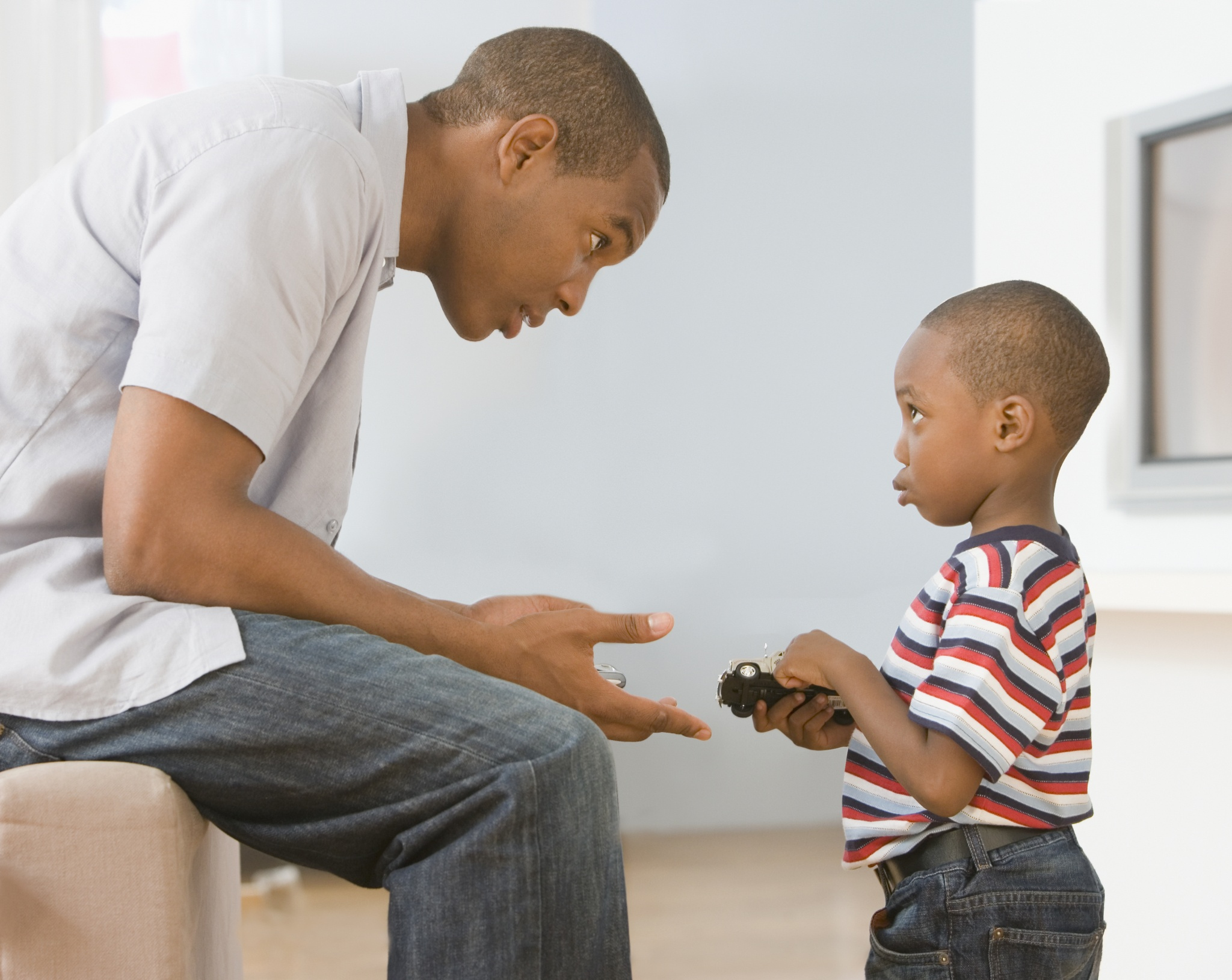 African American father talking to son