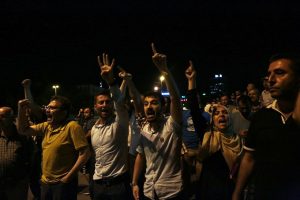 Turkish citizens protest against the coup, in Ankara, Turkey, late Friday, July 15, 2016. Turkey's armed forces said it "fully seized control" of the country Friday and its president responded by calling on Turks to take to the streets in a show of support for the government. A loud explosion was heard in the capital, Ankara, fighter jets buzzed overhead, gunfire erupted outside military headquarters and vehicles blocked two major bridges in Istanbul. (AP Photo/Burhan Ozbilici)