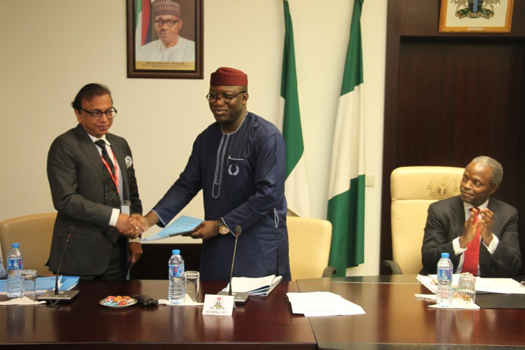 Vice President Yemi Osinbajo (r) watched as Chairman, Global Steel Holdings Limited, Mr Pramod Mittal (left) exchanged documents with the Minister for Solid Minerals Development, Dr Kayode Fayemi; during the signing of the Modified Concession Agreement for the Nigerian Iron Ore Mining Company (NIOMCO) at the State House, Abuja..