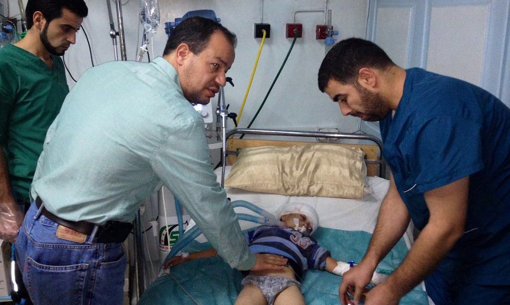 Dr Zaher Sahloul (left, front) treats a child casualty in a Syrian hospital Photograph: Handout