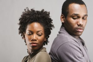 Angry African American couple standing back to back