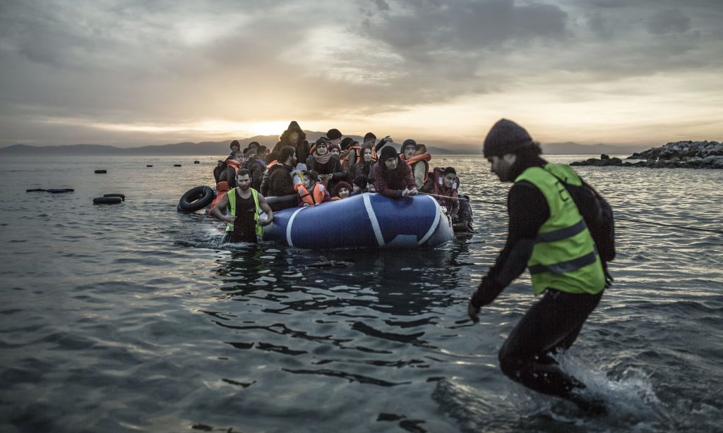 A boat filled with refugees reaches the shore of the small Greek island of Lesbos. Photograph: Pablo Tosco/AP