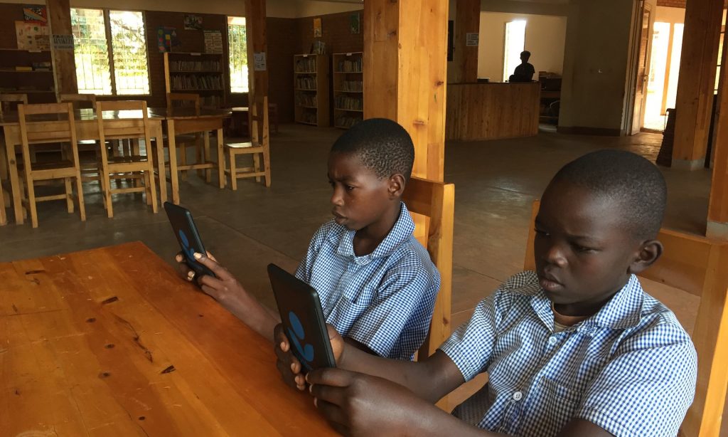 John Kanyambo and Dany Tuyizere, both 12, at a library which where e-readers have been made available thanks to a charity. Photograph: Mark Rice-Oxley for the Guardian