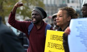 Demonstrators shout slogans and hold placards saying ‘Expression of freedom in Angola’ in March. Photograph: Joao Relvas/EPA