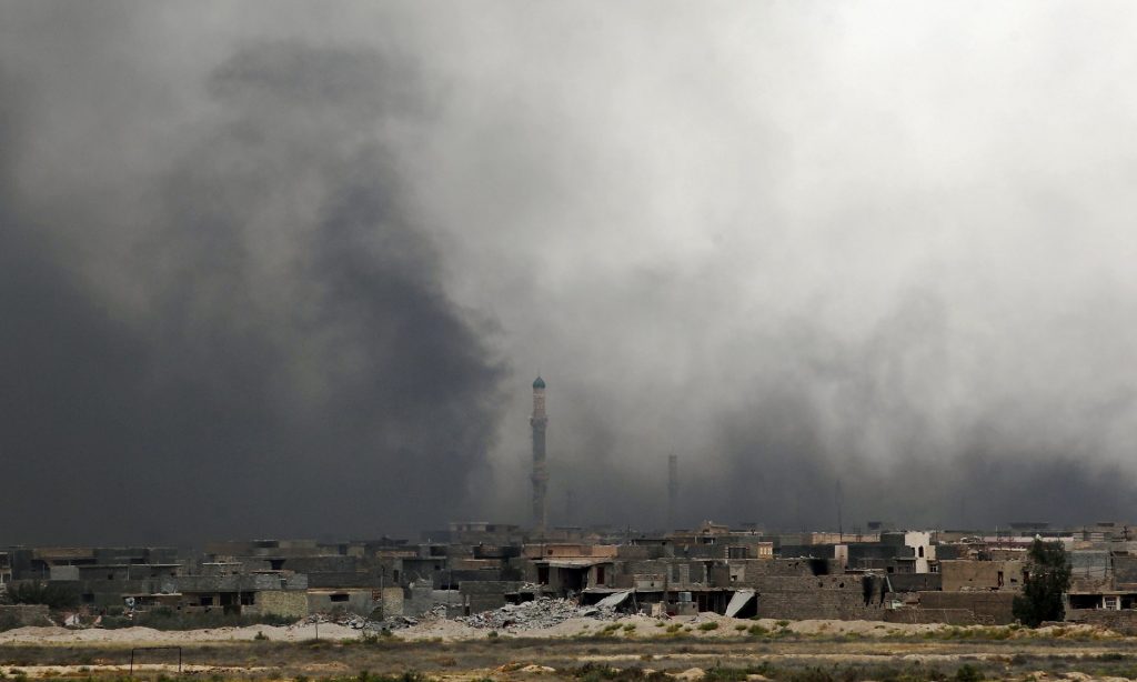 Smoke billows from Fallujah’s southern Shuhada neighbourhood following shelling. Photograph: Ahmad Al-Rubaye/AFP/Getty Images