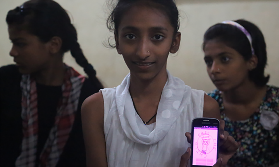 One of the girls in the project displays an app on a smartphone. Photograph: Courtesy of Dharavi Diary