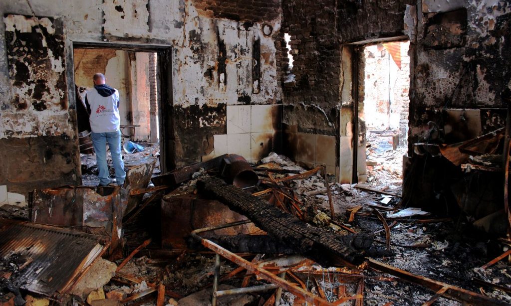 A Médecins Sans Frontières staff member inspects the damage at an MSF hospital in Kunduz, Afghanistan, following a US airstrike. Photograph: Najim Rahim/AFP/Getty Images 
