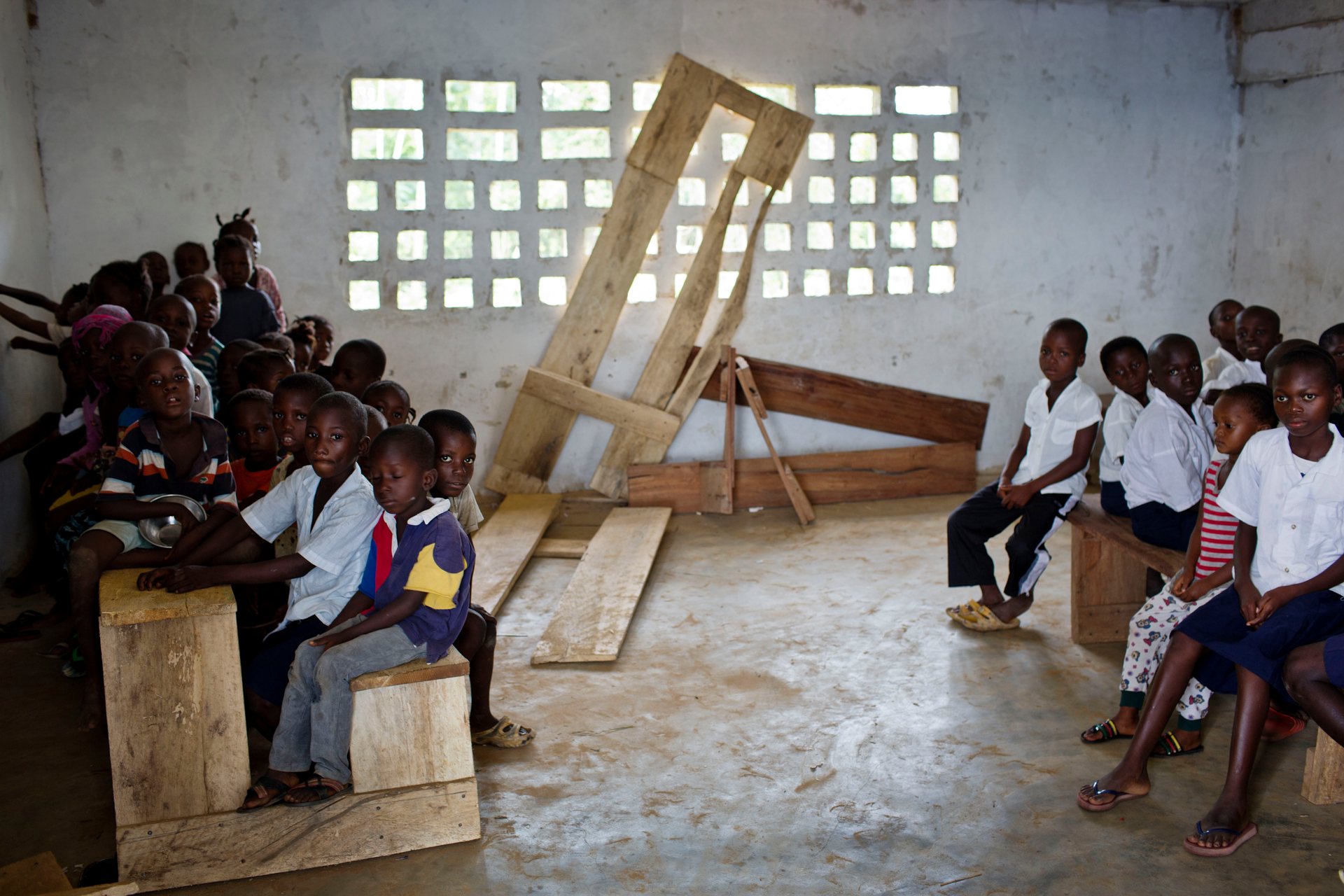 Liberia hopes that by bringing private companies into its education system it can end scenes like this at a Montserrado primary school where children are crammed on to classroom furniture. All photographs by Kate Holt 
