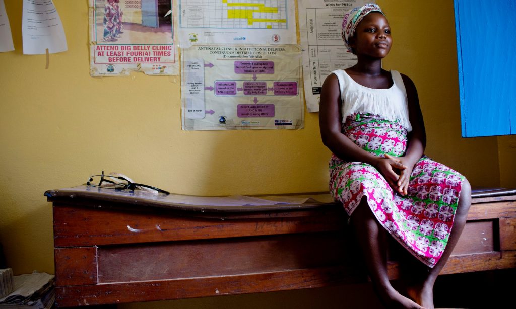 Maria, 17, who is pregnant with her second child, waits to be examined at the Well Baby clinic in Buchanan, Liberia. All photographs by Kate Holt